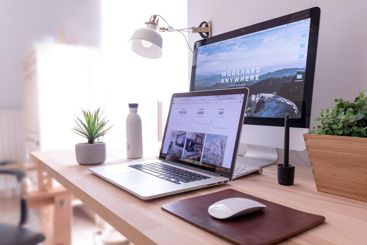 macbook laptop and computer on desk with personal photography website and metrics branding tips for creative businesses