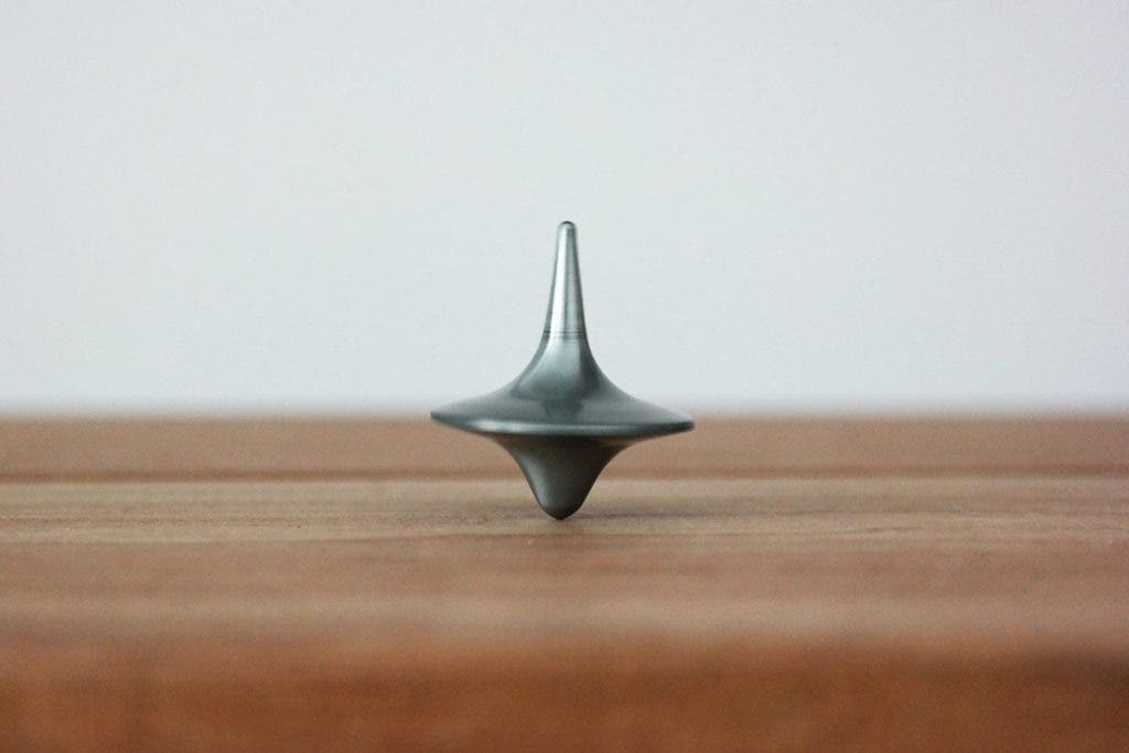 top spinning on table symmetrical balance