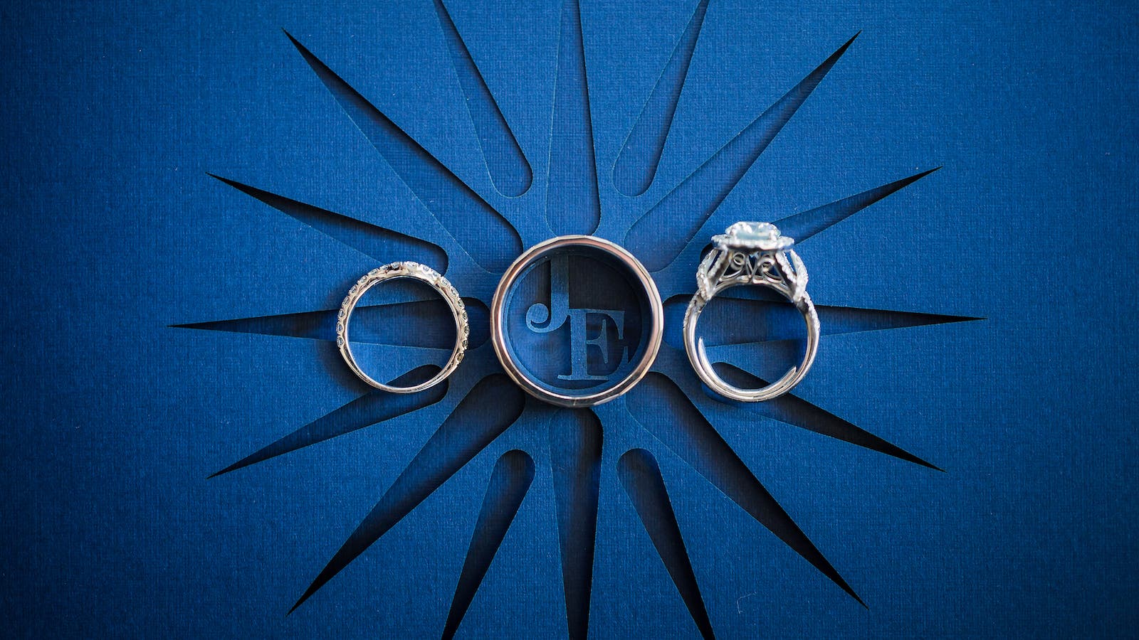 three wedding rings on a wedding invite