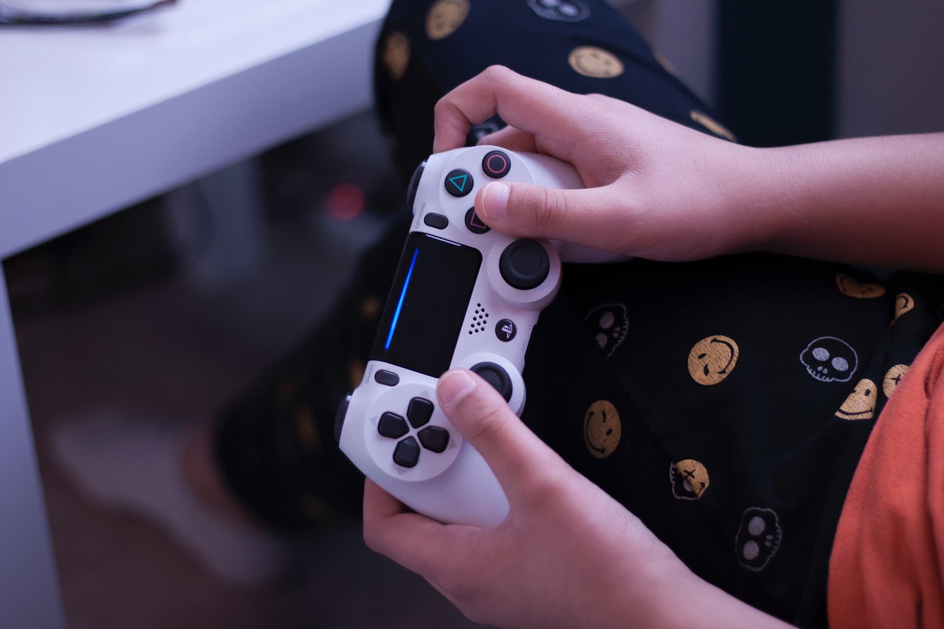 Gamers holding a white Sony PS4