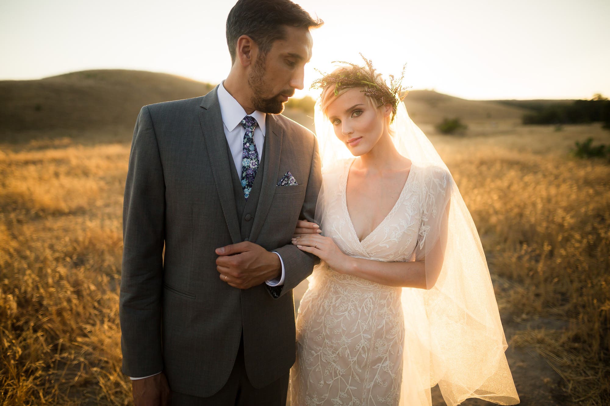 Bride and groom pose for golden hour photography
