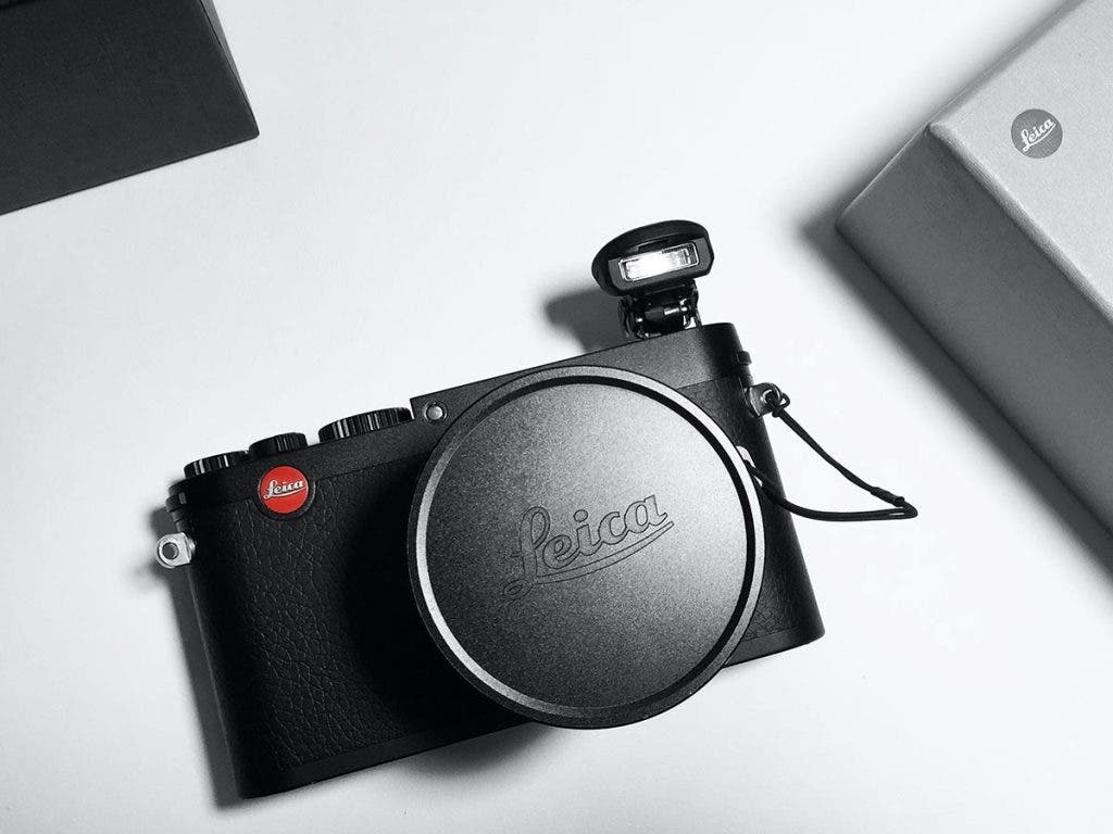 black leica camera for beginners on white table