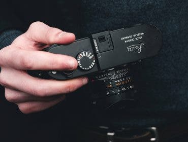 male photographer holding leica camera for beginners