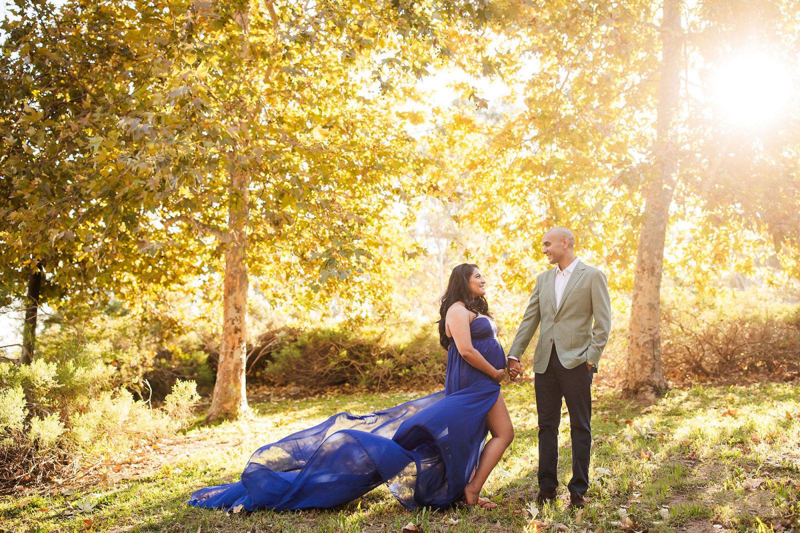 couple poses for maternity shot with colors that pop