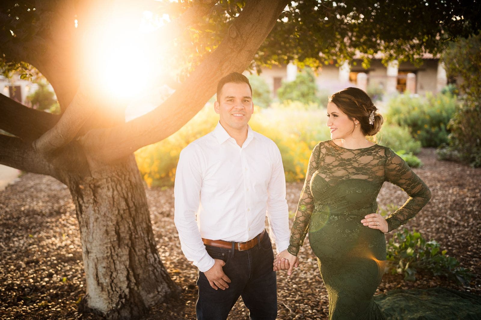 couple poses in front of tree with re-created golden hour lighting