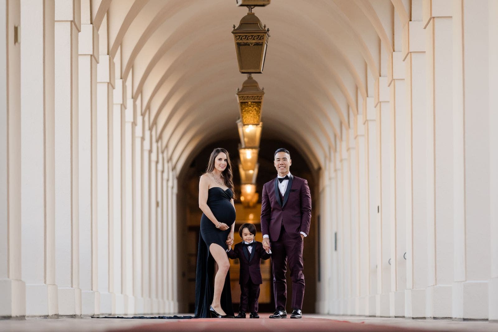 Family poses in hallway for maternity picture ideas