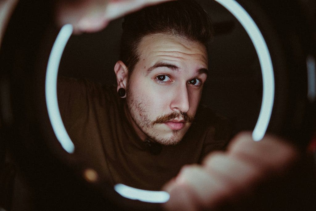 Man using a ring light instead of umbrella lighting