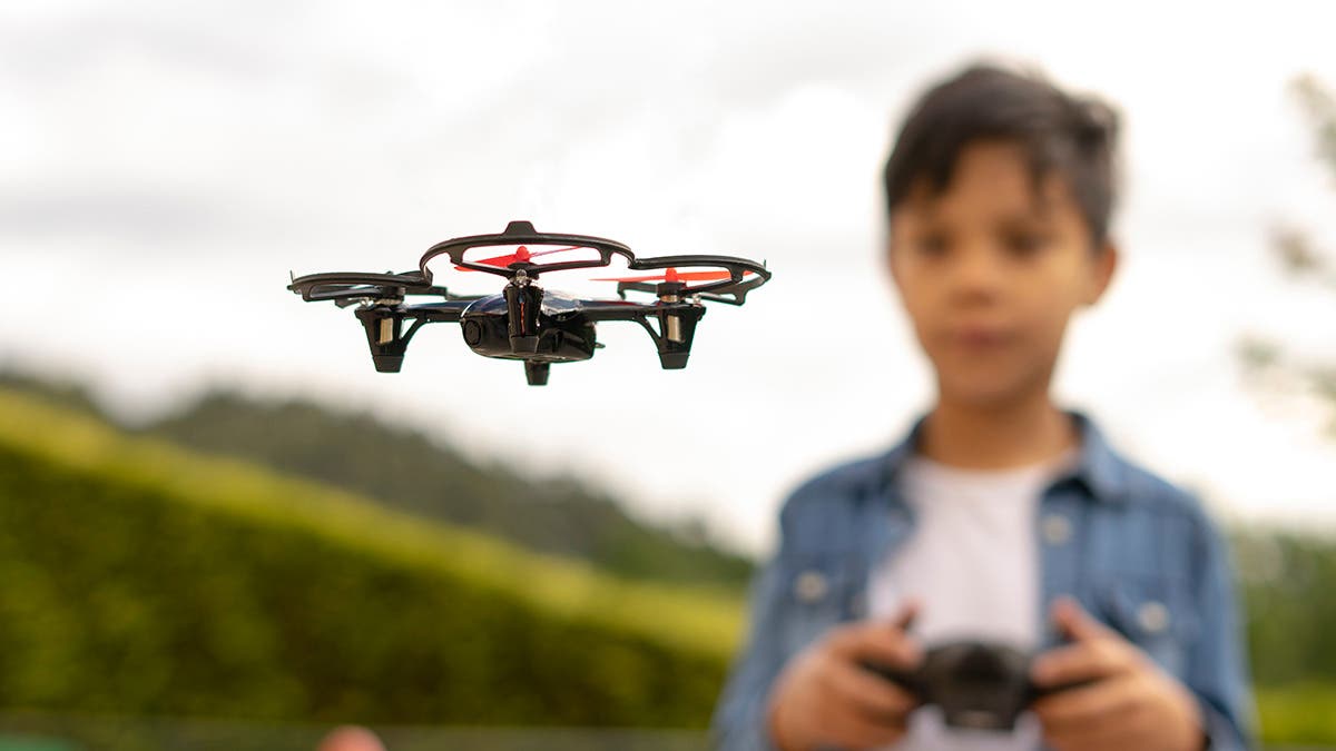young boy flying a drone