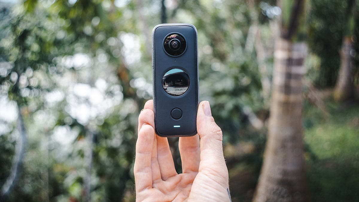 person holding black and gray camera insta360 one x2 camera