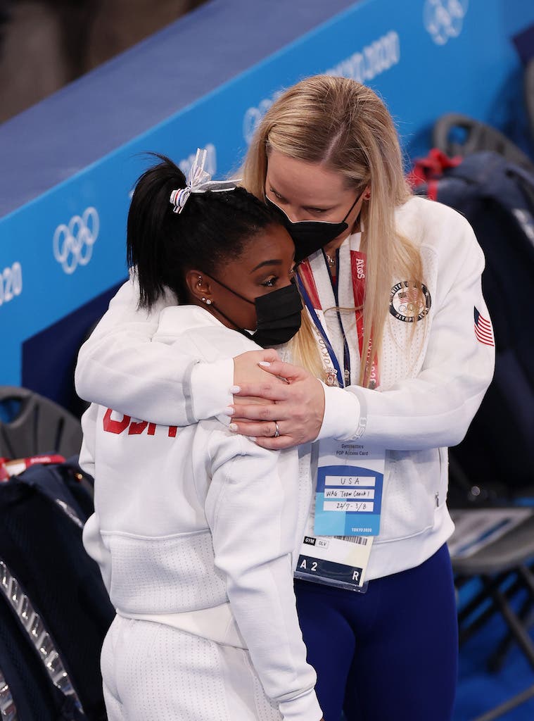 TOKYO, JAPAN - JULY 27: Simone Biles of Team United States is embraced by coach Cecile Landi during the Women's Team Final on day four of the Tokyo 2020 Olympic Games at Ariake Gymnastics Centre on July 27, 2021 in Tokyo, Japan. (Photo by Jamie Squire/Getty Images)