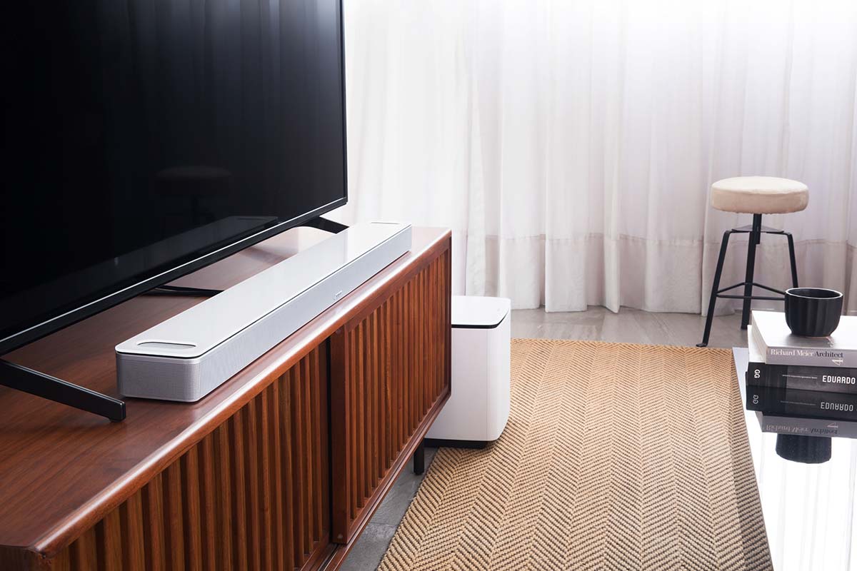 Bose soundbar 900 in living room with tv and speaker