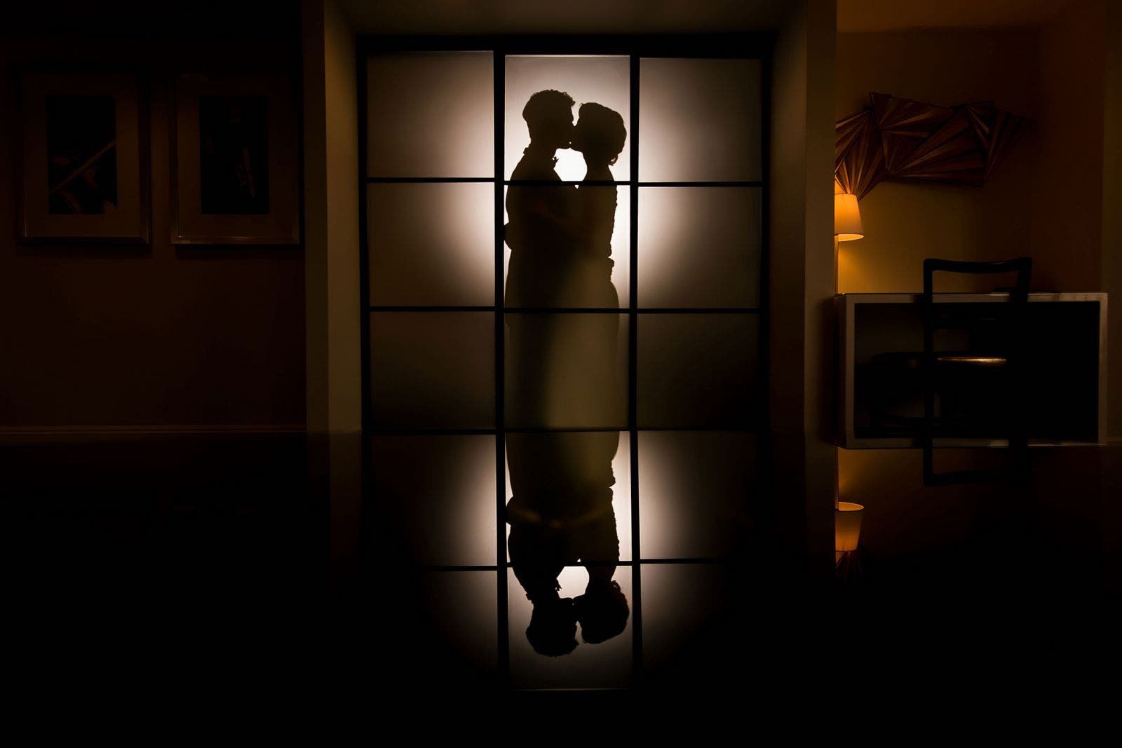 silhouette photography example for environmental room portrait featuring couple