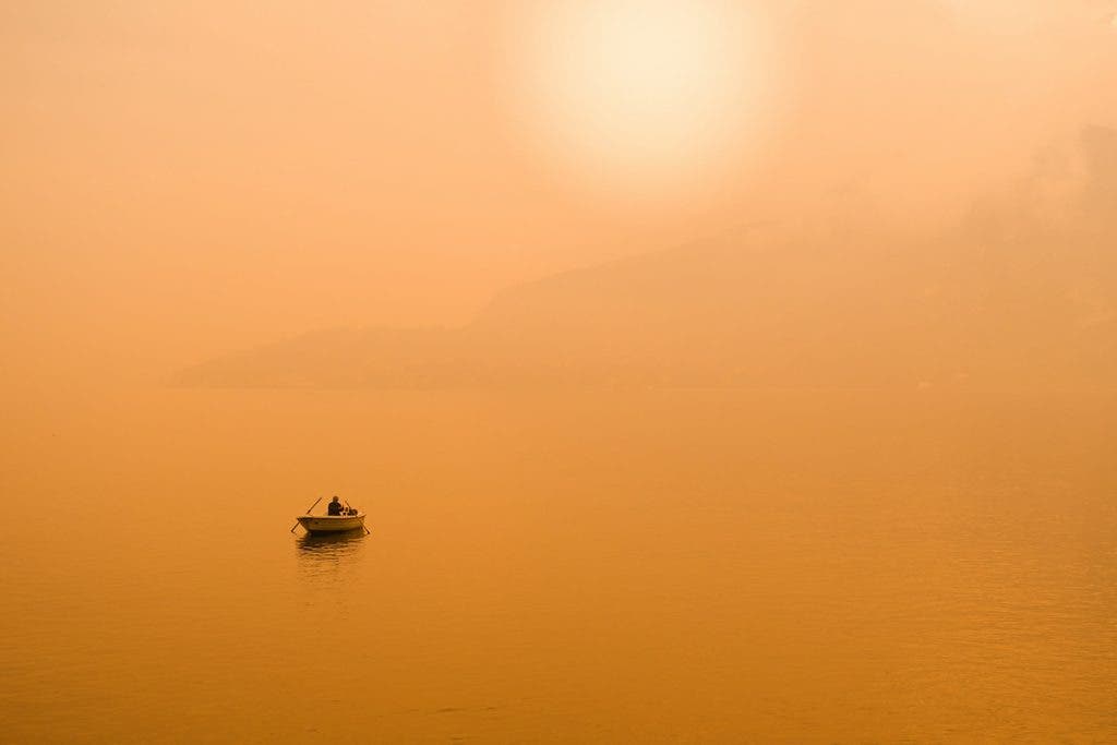 boat in water during yellow sunset