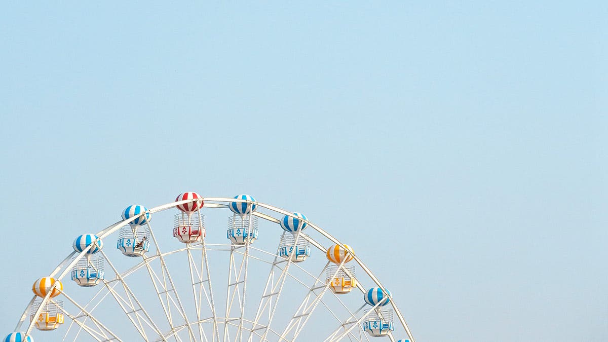 ferris wheel against blue sky negative space photography