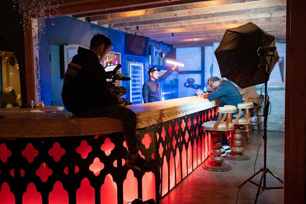 filmmaker shooting bar scene with actor and lighting