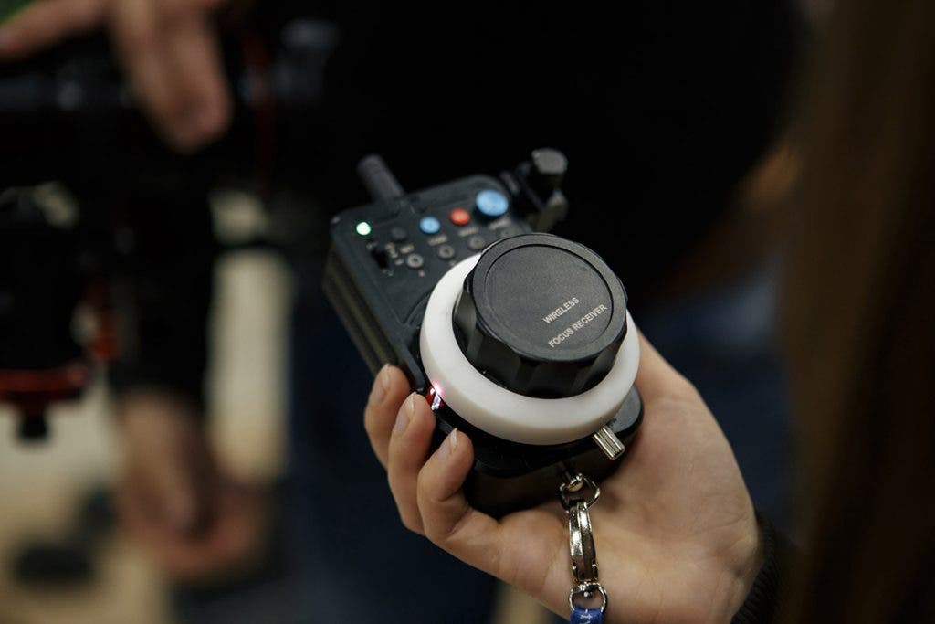 person holding follow focus system