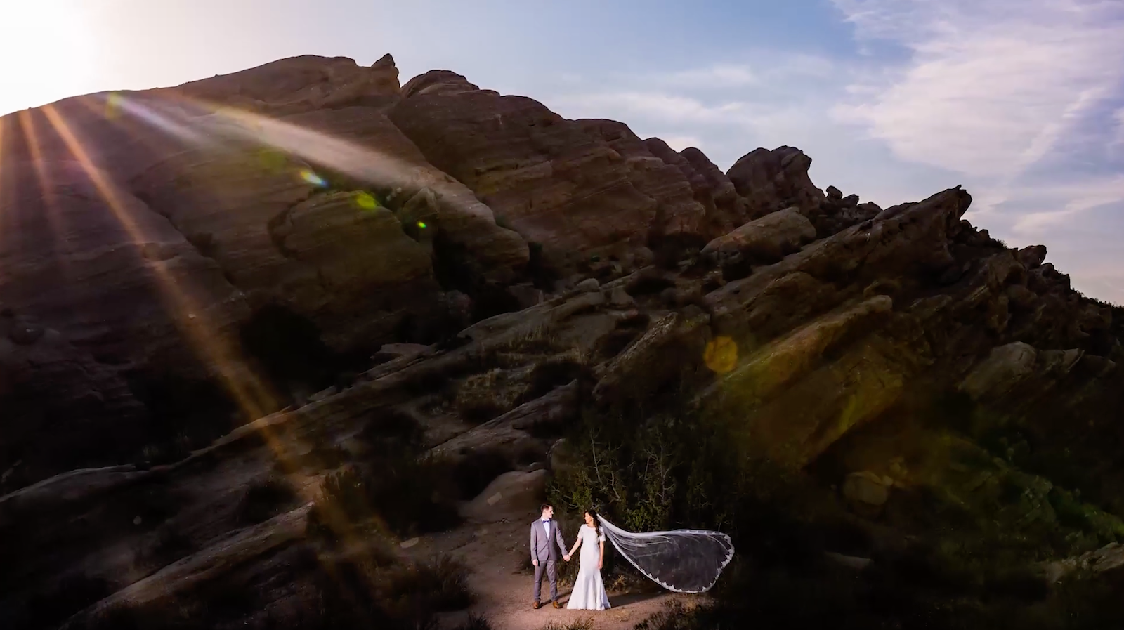 couple standing in front of rocks at night