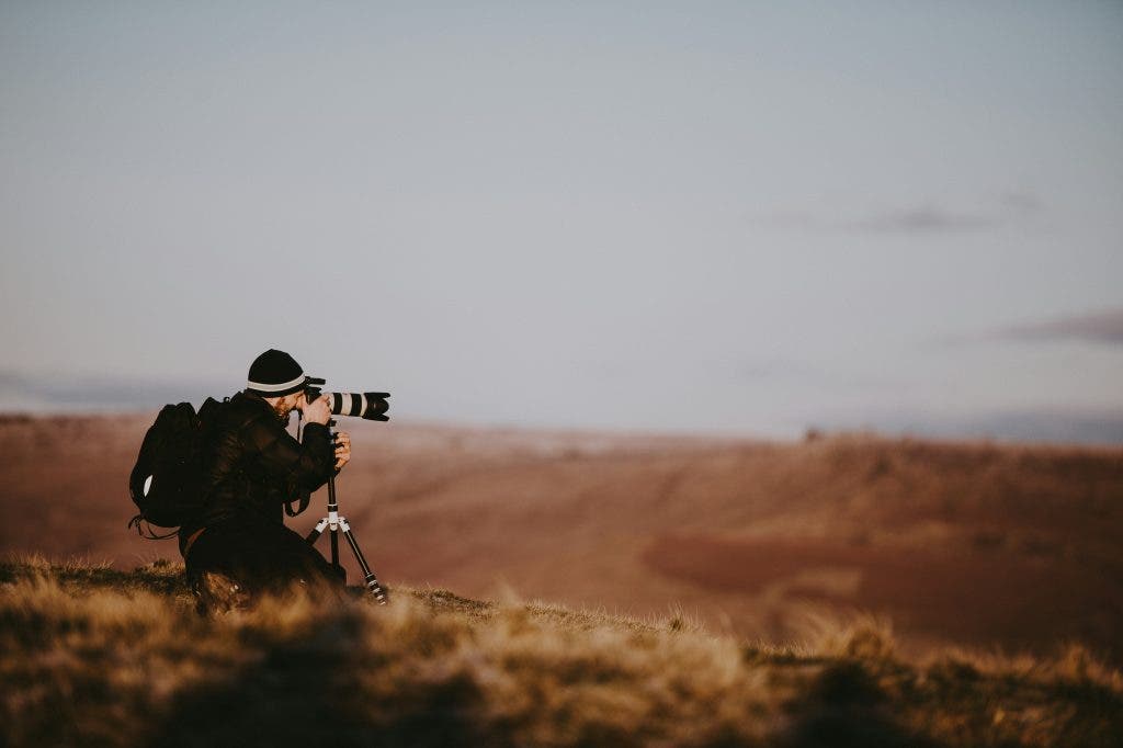 Photographer using tripod for not blurry photos
