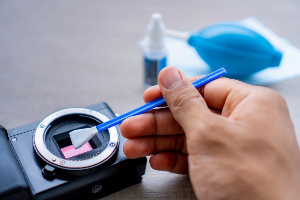 cleaning camera sensor with brush and liquid