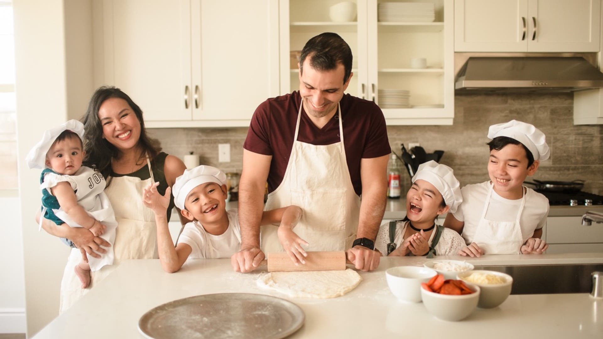 family making pizza