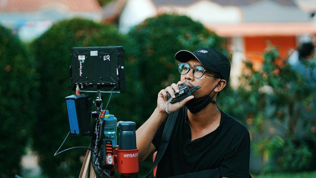 film director on set looking at footage