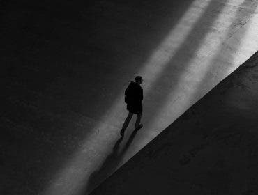 Man walking in shadows