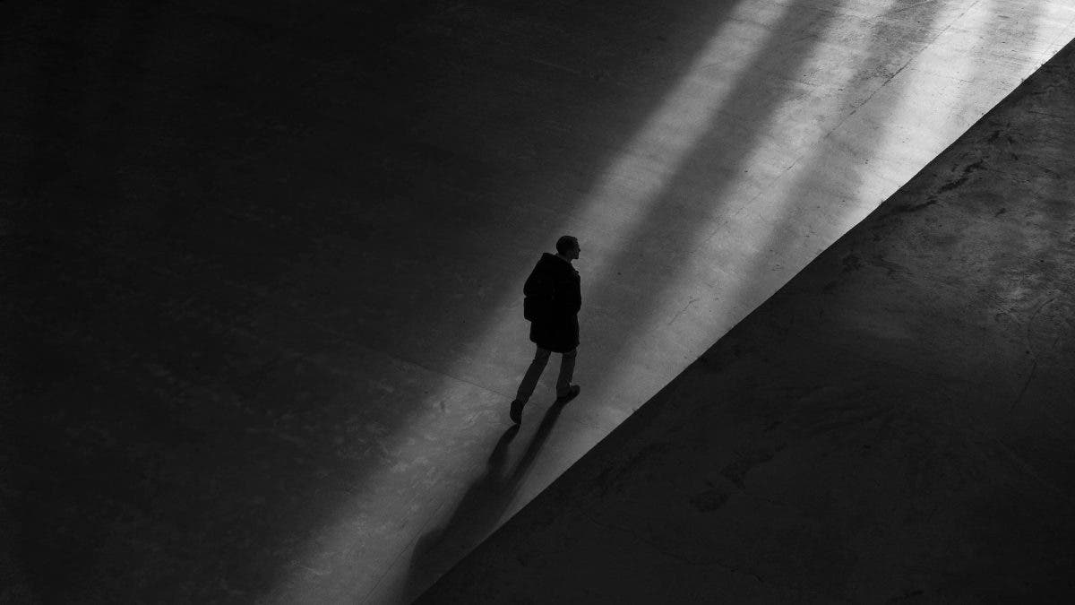 Man walking in shadows