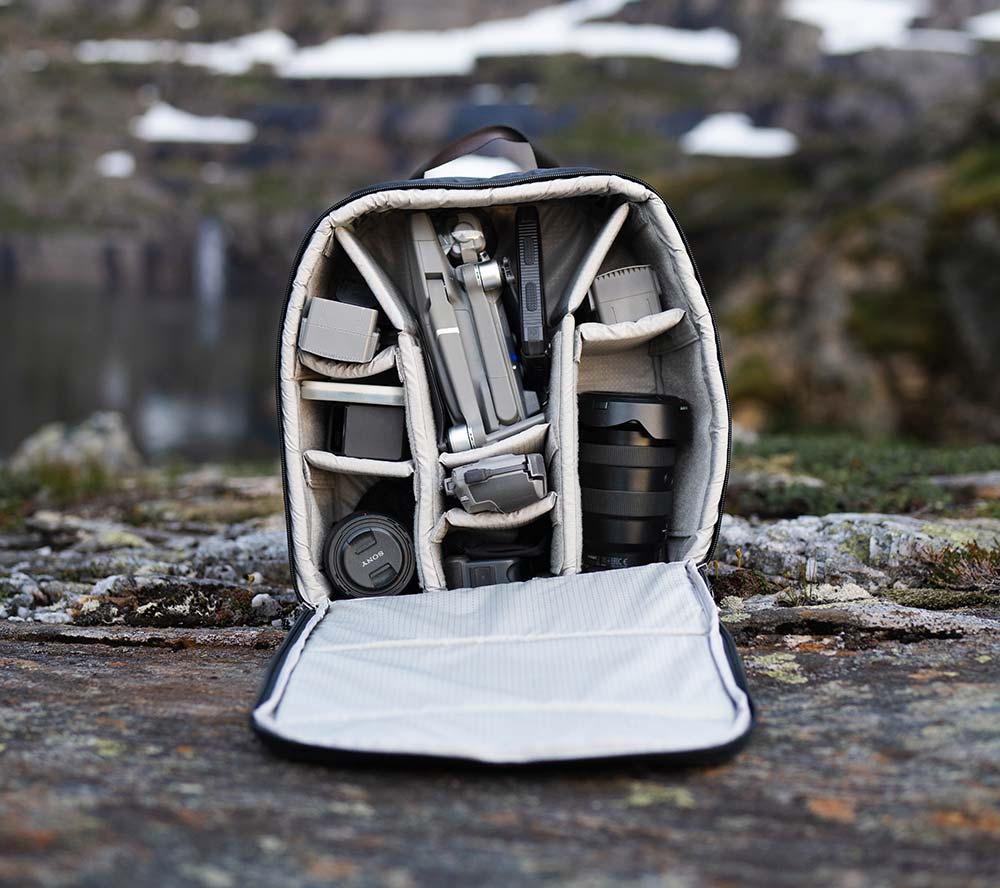 travel photography backpack with camera lens and drone
