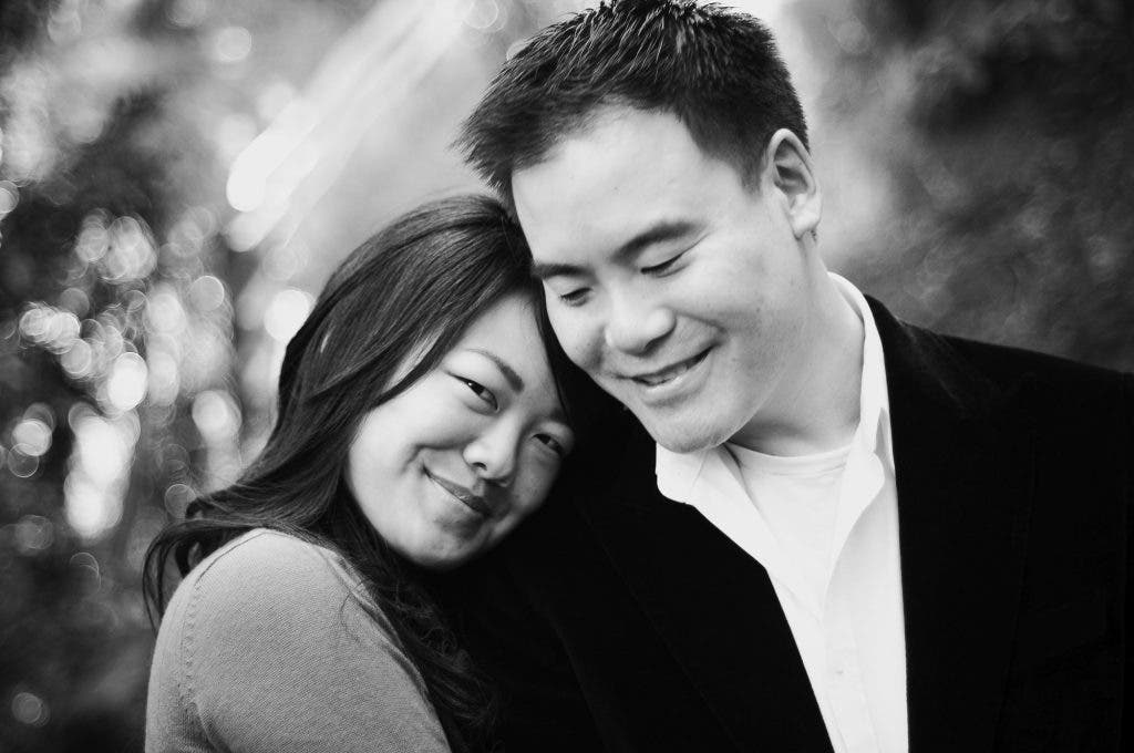 Couple leans in to show how to smile for pictures