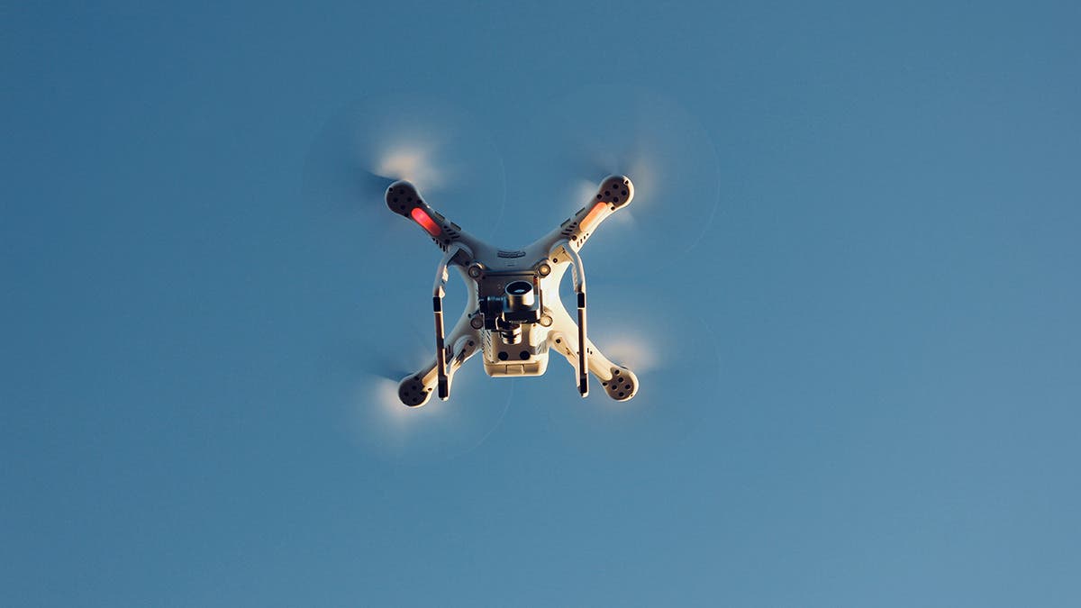 drone flying upward in sky