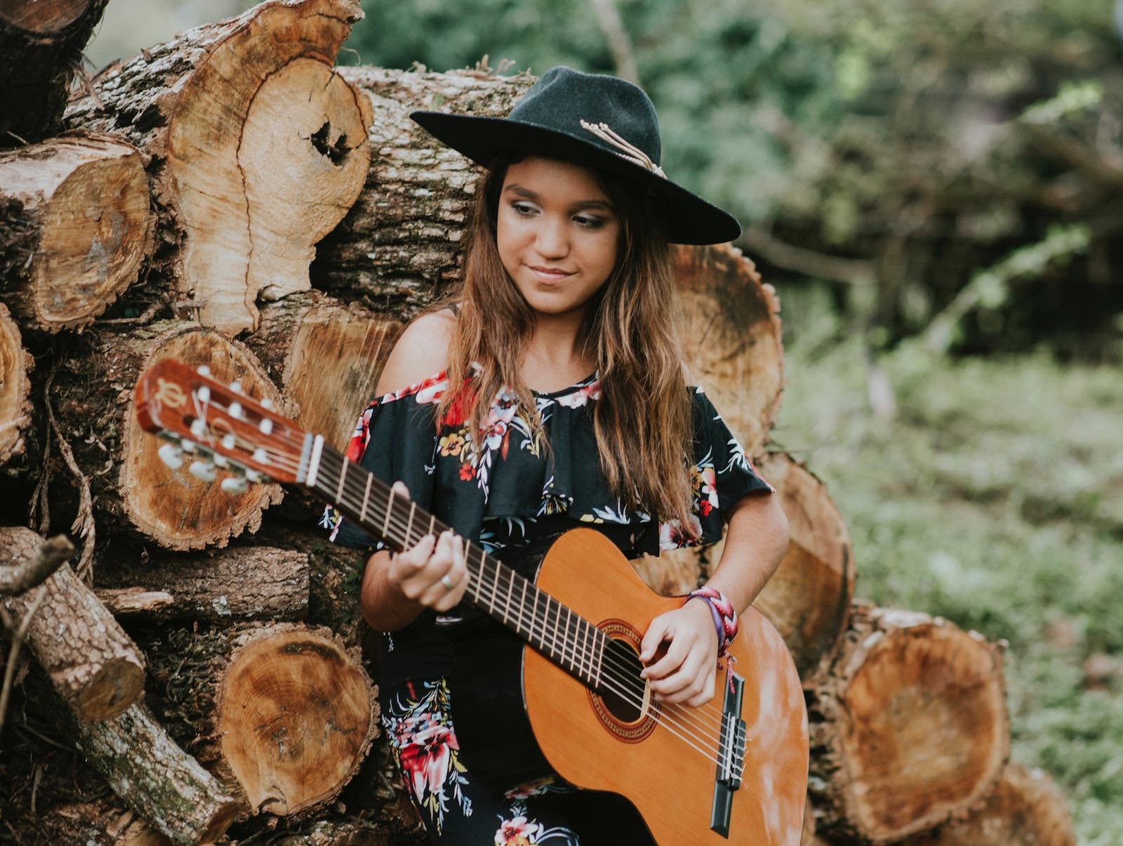 girl plays guitar for senior picture ideas