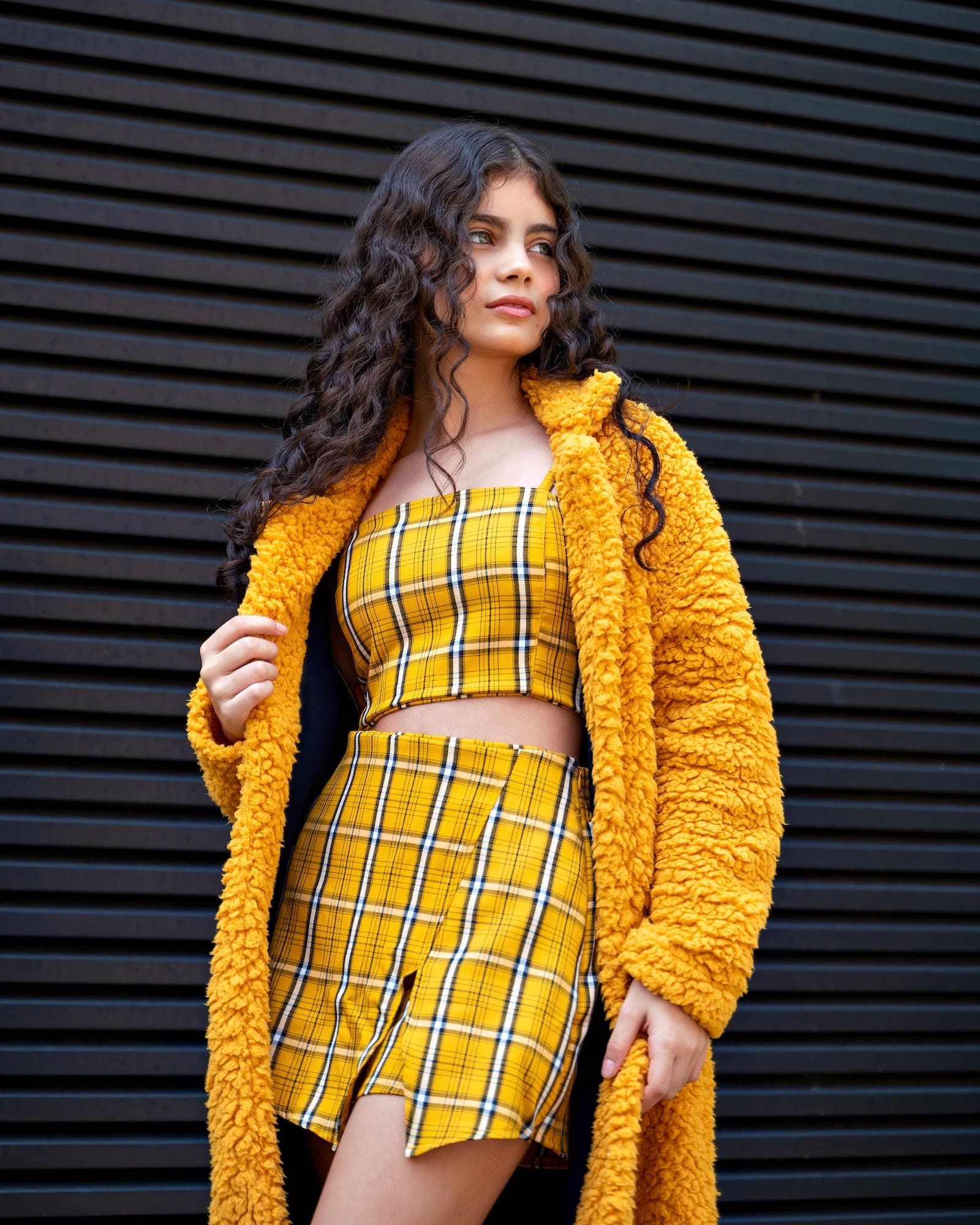Girl standing in yellow outfit