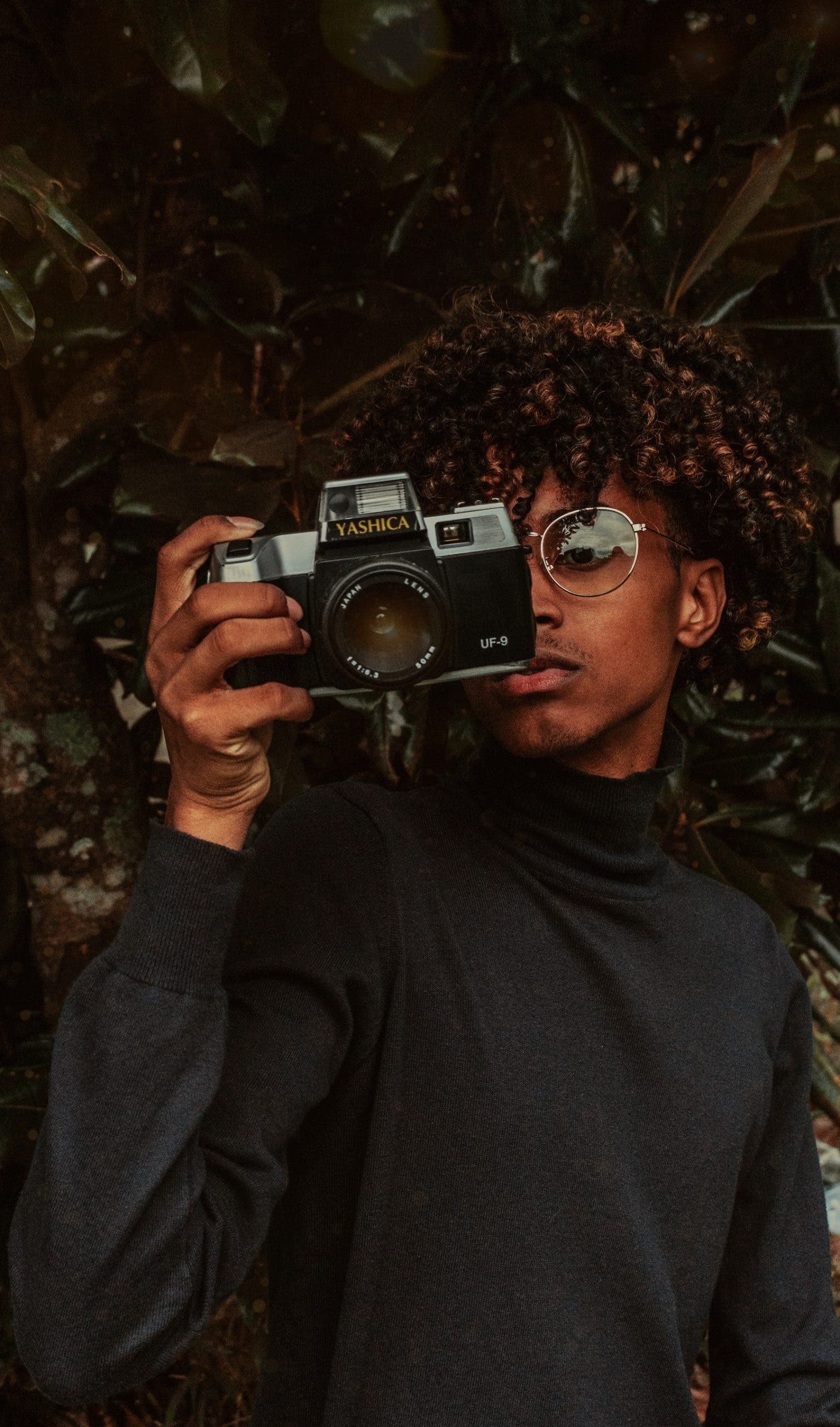student with camera for senior picture ideas