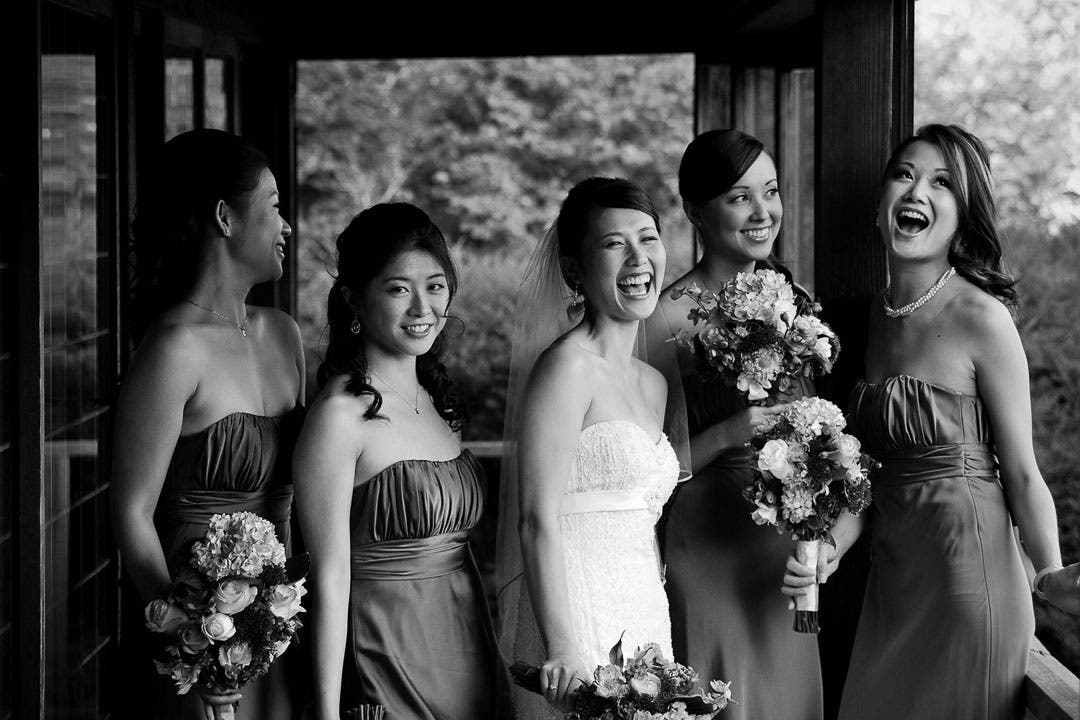 A bride stands with her bridesmaids
