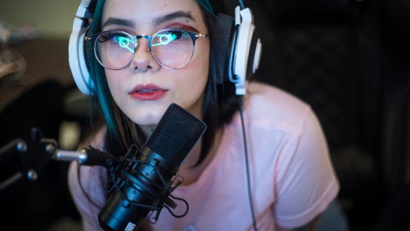 Young woman with headphones and microphone live streaming