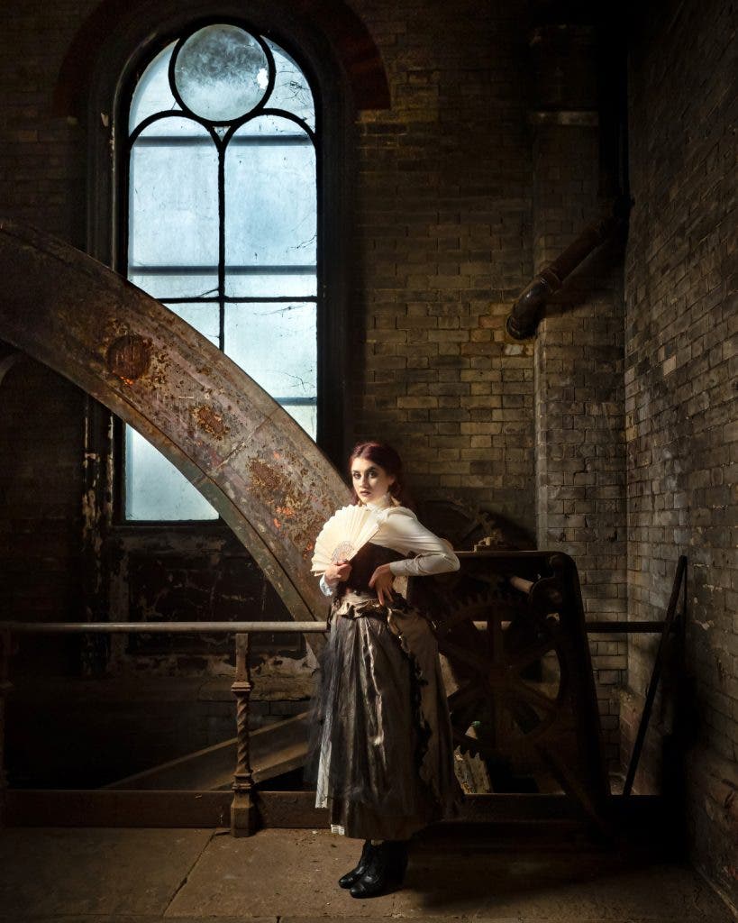 The best portrait lens for showing an environment is often a wide angle like this shot of a model near a window in an old brick building.