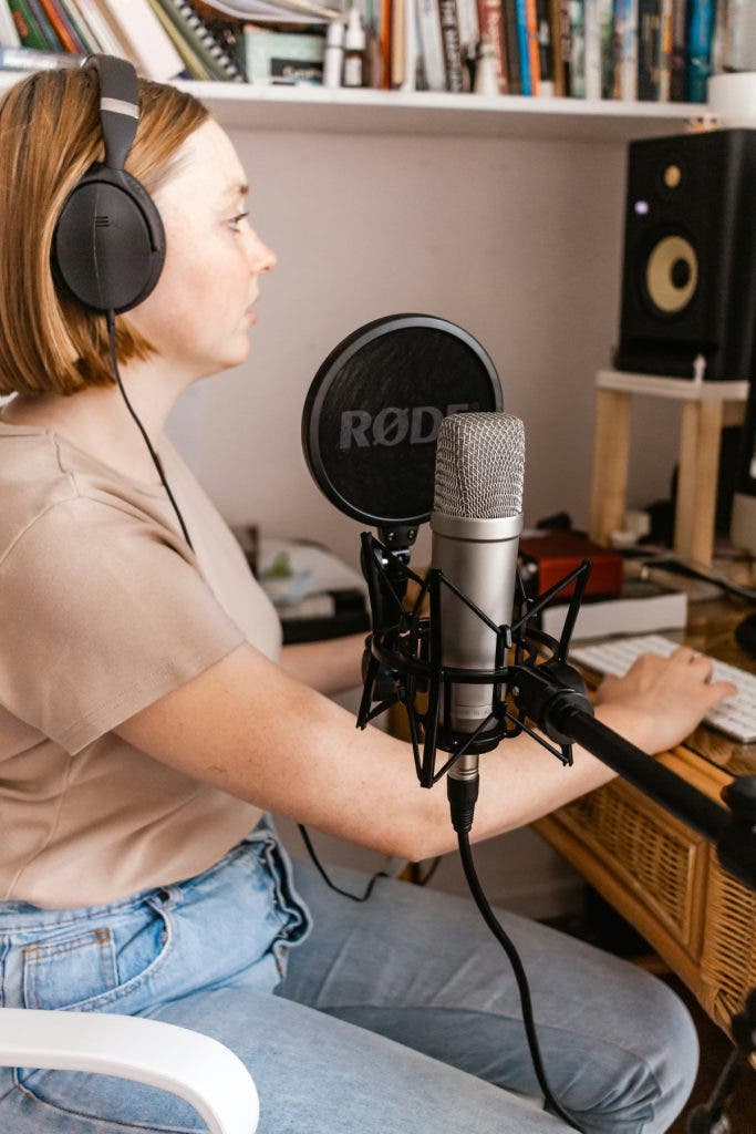 Young woman streaming with microphone on a boom arm