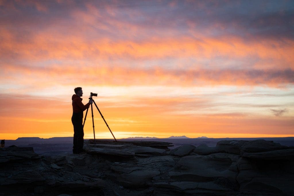 A silhouette of a photographer out there shooting to improve their photography