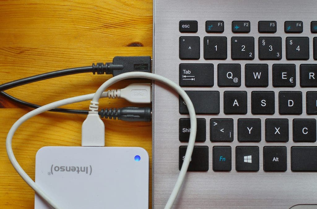 a hard drive hooked up to a small laptop