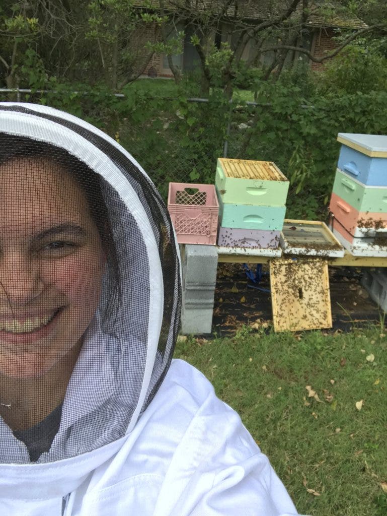 Selfie of Conservation Photographer Brooke McDonough and bee hives.