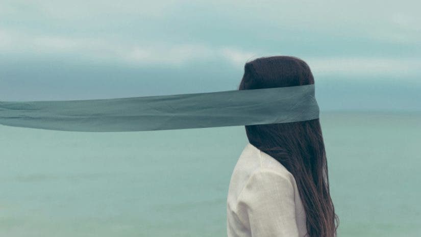 Portrait of a woman with a scarf, the scarf seems to blend into the horizon - the effect is surreal
