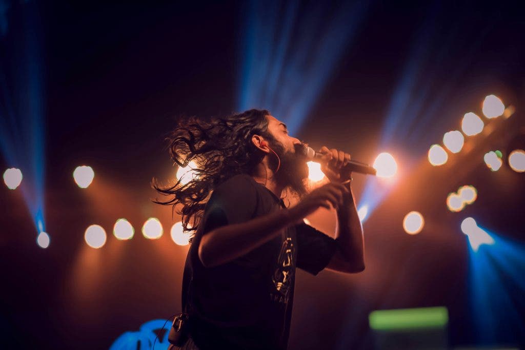 a man performing on stage with a microphone