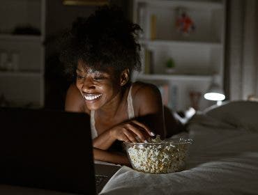 woman lit by laptop screen with lamp behind her for practical use of lights via adobe stock.