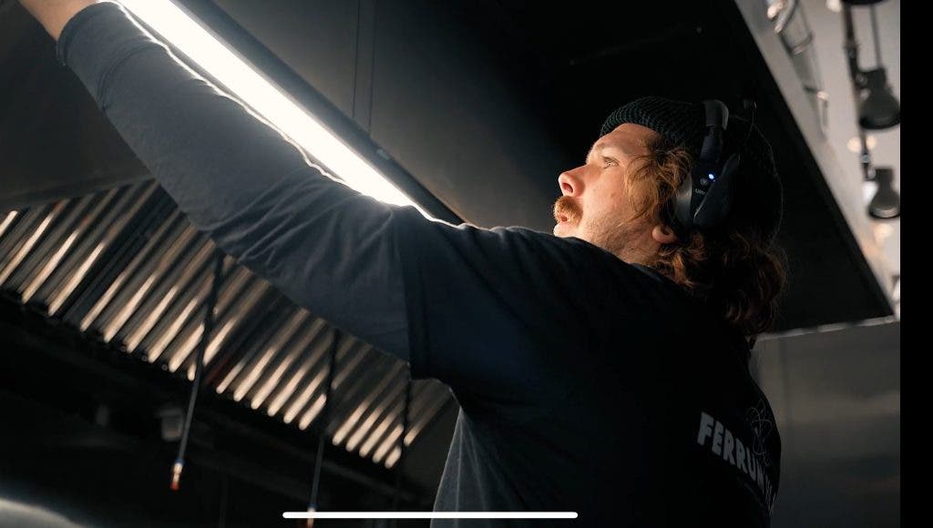 Photographers placing lighting on set of a brand film