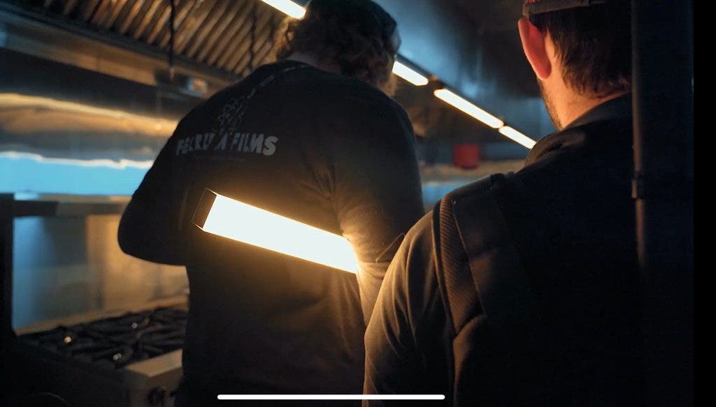 Photographers setting up lighting on a brand film set