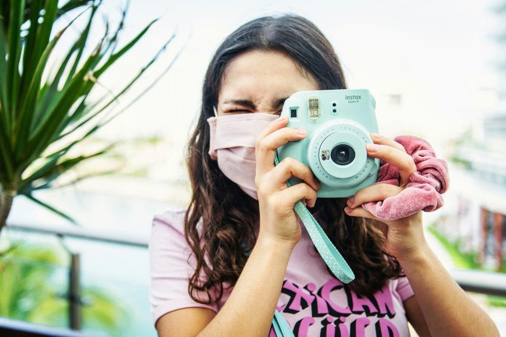 Girl holding Instax Mini 9 Camera
