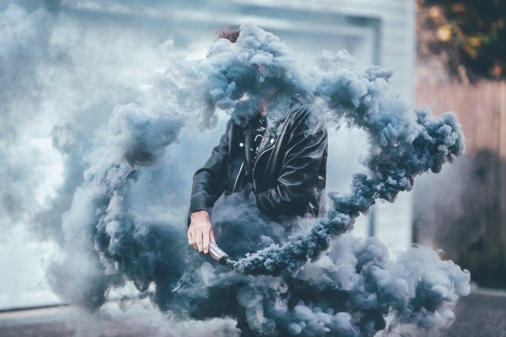 Man poses with smoke in creative photography shoot