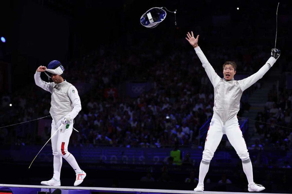 PARIS, FRANCE - JULY 29: Ka Long Cheung of team Hong Kong (R) and Filippo Macchi of team Italy react during the Fencing Men's Foil Individual Gold Medal Bout on day three of the Olympic Games Paris 2024 at Grand Palais on July 29, 2024 in Paris, France. (Photo by Al Bello/Getty Images)