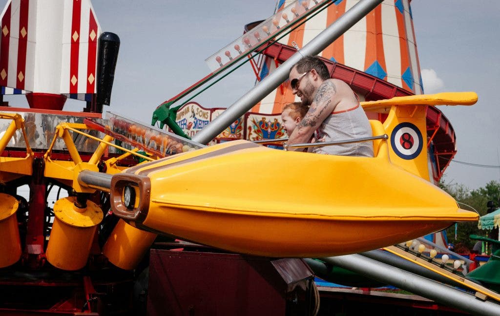 Man on carnival ride in gloomy weather