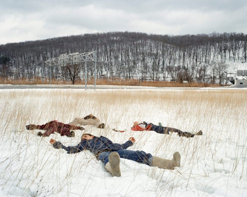 A group of people lay down on the snow